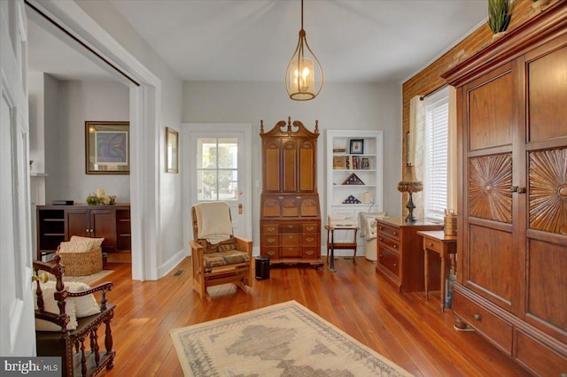 living area featuring plenty of natural light and light hardwood / wood-style flooring