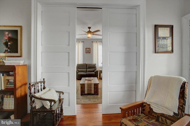 sitting room featuring hardwood / wood-style floors and ceiling fan