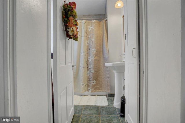 bathroom featuring tile patterned flooring and curtained shower