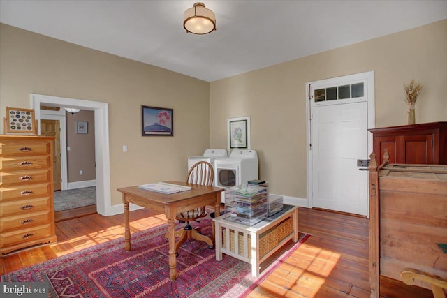 office space with hardwood / wood-style flooring and washer and clothes dryer