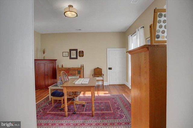 home office with wood-type flooring