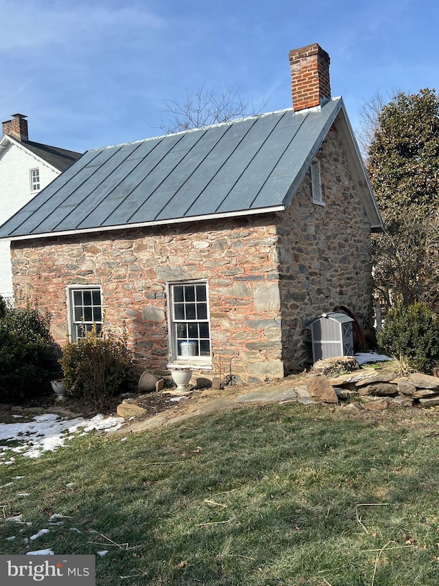 view of side of property featuring central air condition unit and a lawn