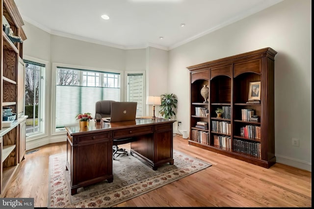 office with ornamental molding and light hardwood / wood-style flooring