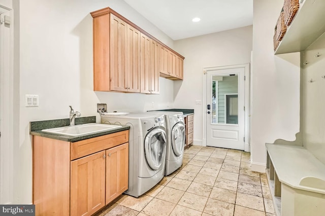 washroom featuring cabinets, sink, and independent washer and dryer