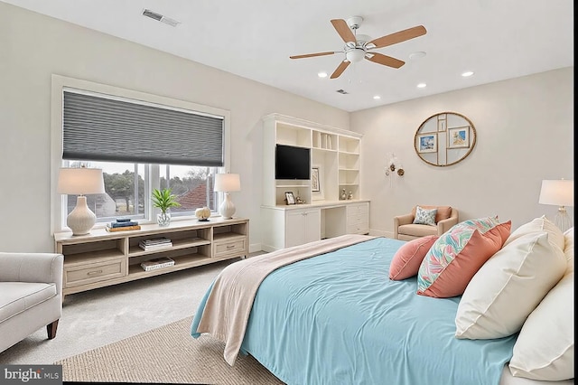 bedroom featuring ceiling fan and light carpet