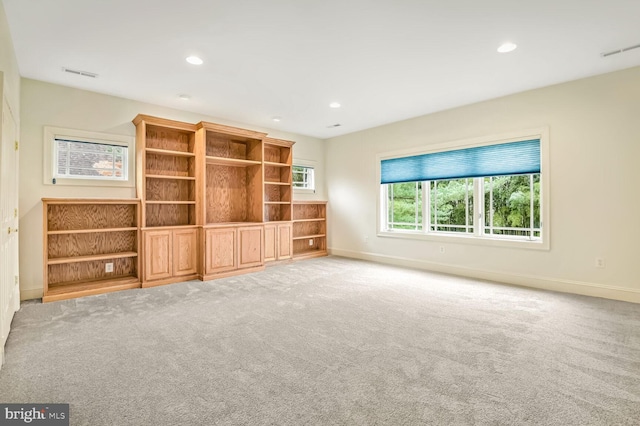 unfurnished living room featuring light carpet