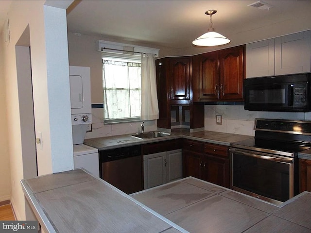 kitchen with stacked washing maching and dryer, sink, hanging light fixtures, dark brown cabinetry, and stainless steel appliances