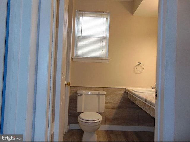 bathroom featuring wood-type flooring and toilet