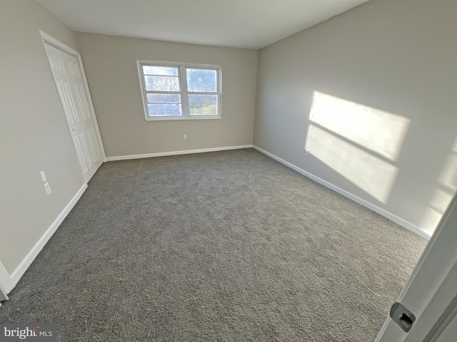 interior space with dark colored carpet