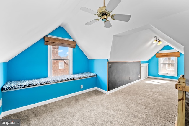 additional living space with lofted ceiling, carpet floors, ceiling fan, and baseboards