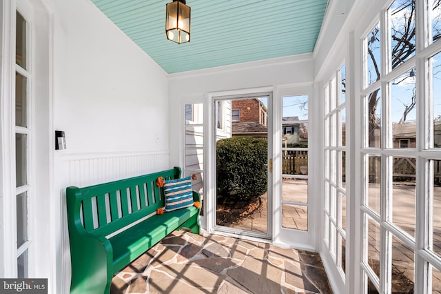 sunroom featuring lofted ceiling