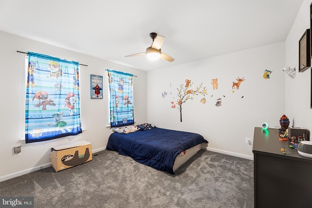 bedroom featuring ceiling fan and dark carpet