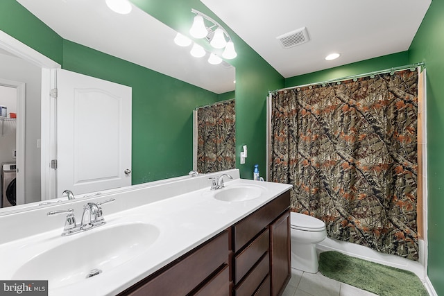 bathroom featuring washer / dryer, vanity, walk in shower, toilet, and tile patterned floors