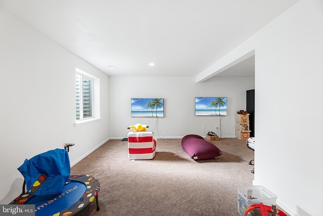 playroom with carpet and beam ceiling