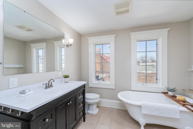 bathroom with plenty of natural light, tile patterned flooring, vanity, and a bathtub