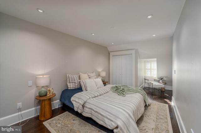 bedroom with dark wood-type flooring and a closet