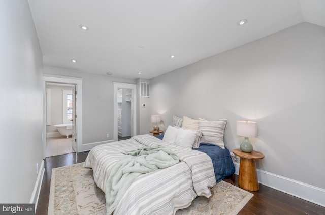 bedroom with dark hardwood / wood-style floors and vaulted ceiling