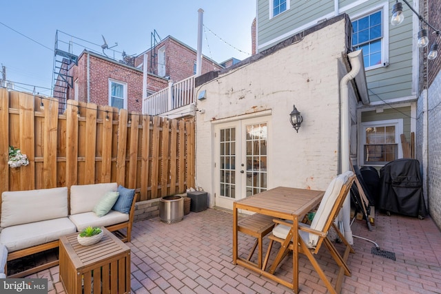 view of patio featuring french doors, grilling area, and outdoor lounge area