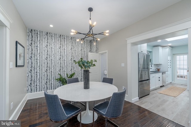 dining space with a chandelier and hardwood / wood-style floors