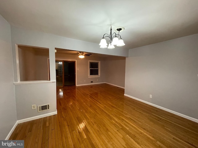 interior space featuring hardwood / wood-style flooring and ceiling fan with notable chandelier