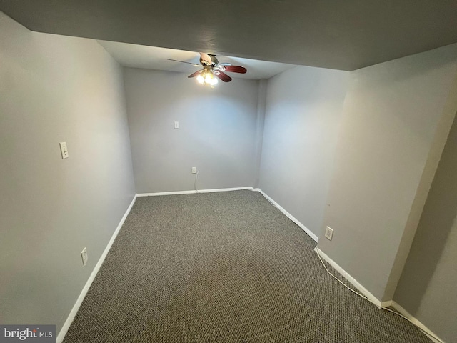 carpeted spare room featuring ceiling fan