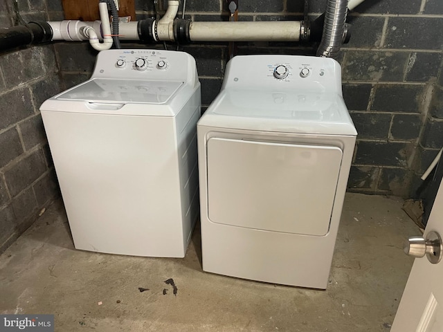 clothes washing area with washing machine and clothes dryer