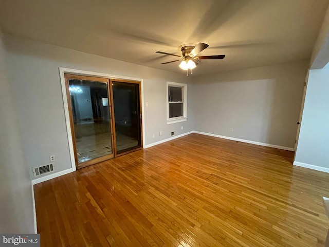 unfurnished room with ceiling fan and wood-type flooring