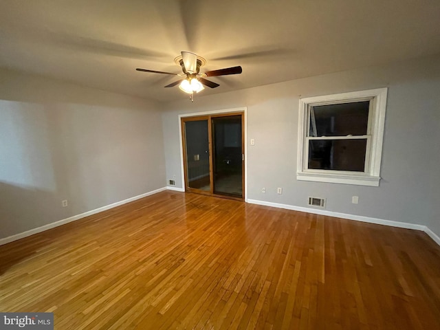 spare room with ceiling fan and wood-type flooring