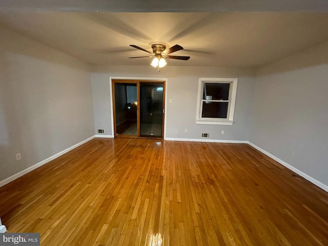 empty room with hardwood / wood-style flooring and ceiling fan