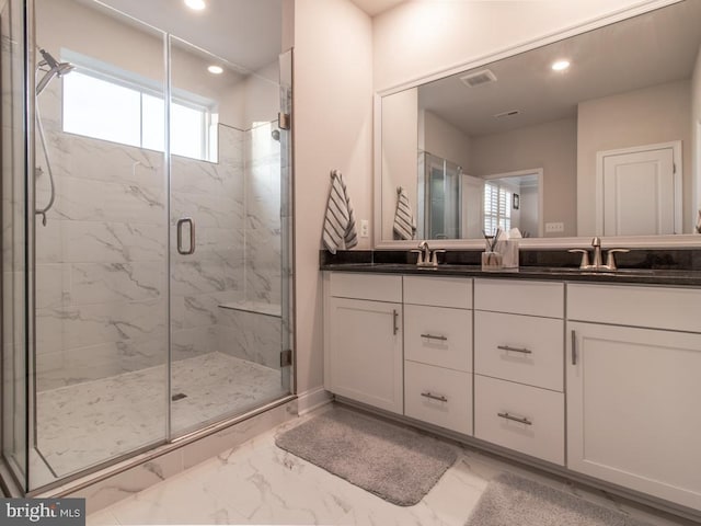 bathroom featuring vanity and a shower with shower door