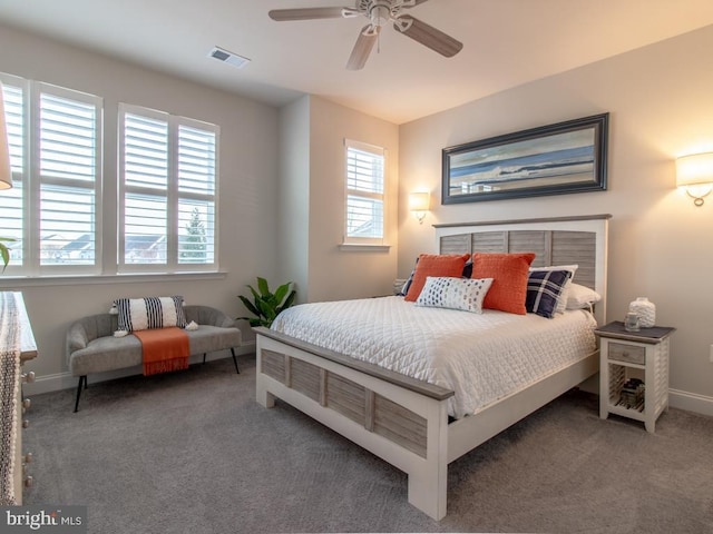 carpeted bedroom with multiple windows and ceiling fan