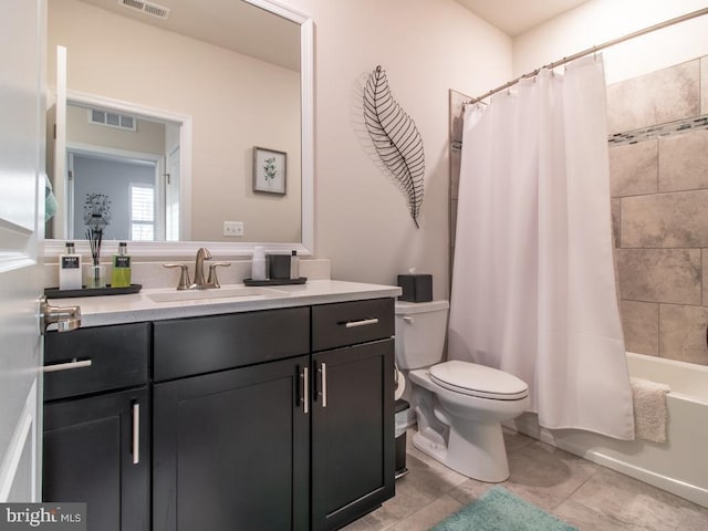 full bathroom with shower / tub combo, vanity, tile patterned floors, and toilet