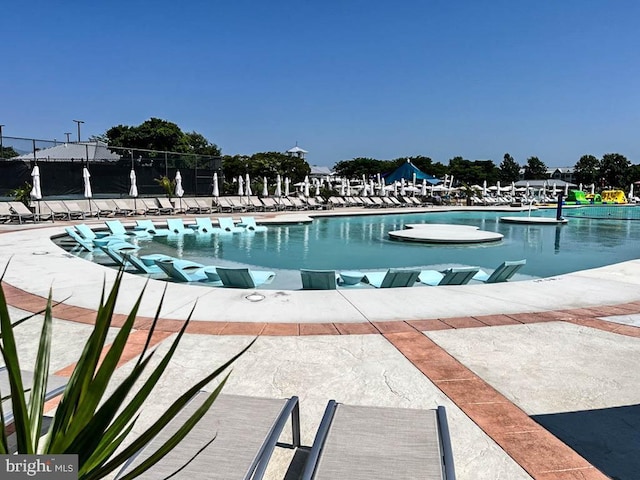 view of swimming pool featuring a patio area