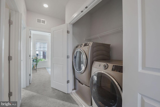 laundry area with light carpet and washing machine and dryer