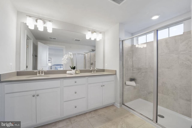 bathroom featuring tile patterned floors, vanity, and an enclosed shower