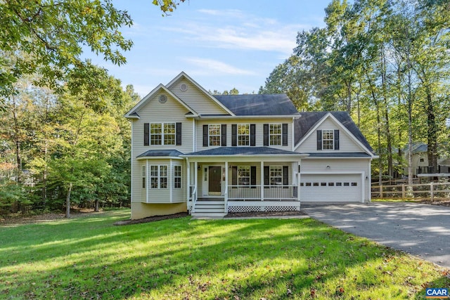 view of front facade featuring a garage, a front lawn, and covered porch