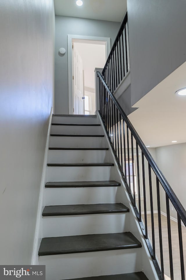 stairs featuring recessed lighting, baseboards, and wood finished floors