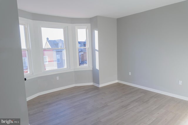 empty room featuring baseboards and wood finished floors