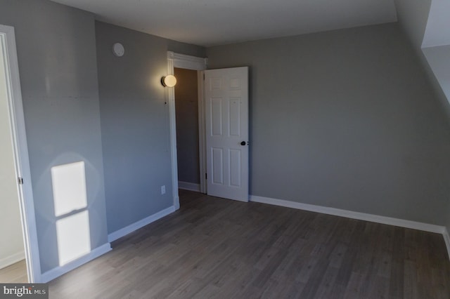 interior space featuring baseboards and wood finished floors