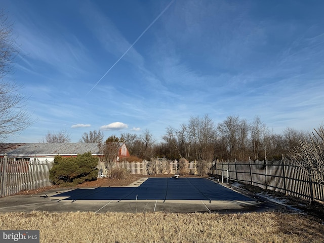 view of yard featuring a patio area and a covered pool