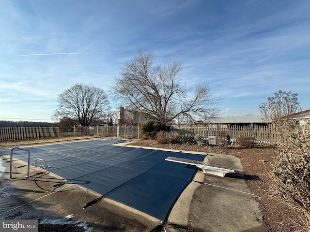 view of pool featuring a diving board