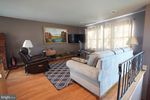 living room with a baseboard radiator and hardwood / wood-style floors