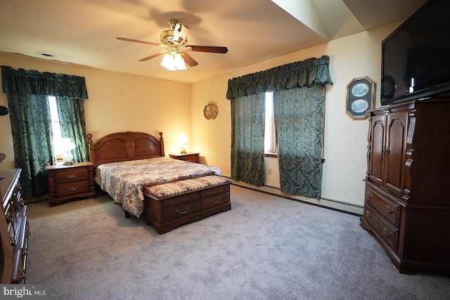 carpeted bedroom with baseboard heating, ceiling fan, and multiple windows