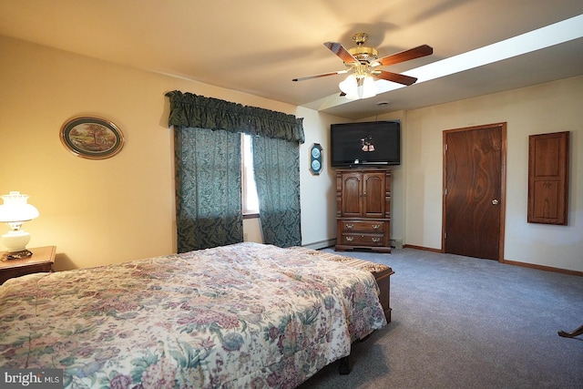 carpeted bedroom with a baseboard radiator and ceiling fan