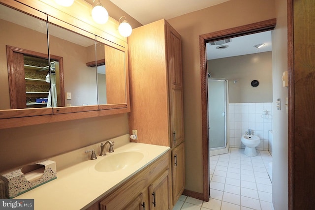 bathroom featuring tile patterned floors, tile walls, a bidet, vanity, and a shower with door