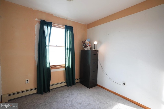 unfurnished bedroom featuring carpet flooring and baseboard heating