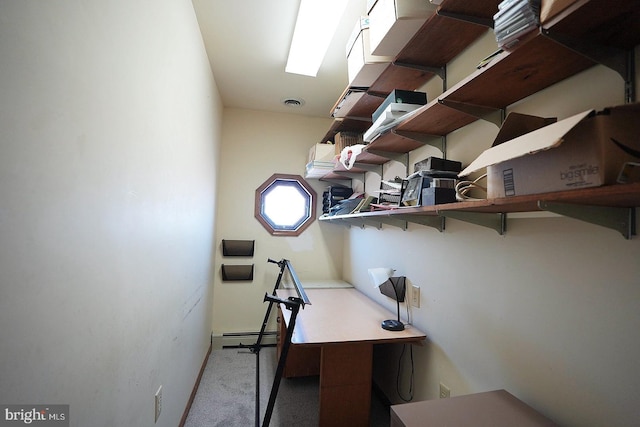 unfurnished office featuring a baseboard radiator and light carpet