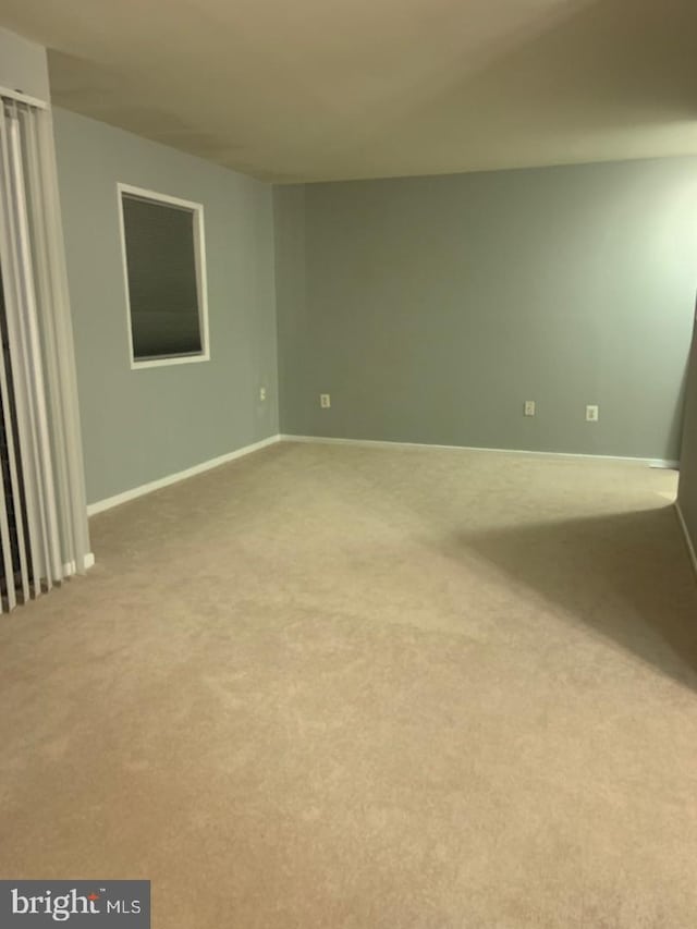 spare room with light colored carpet