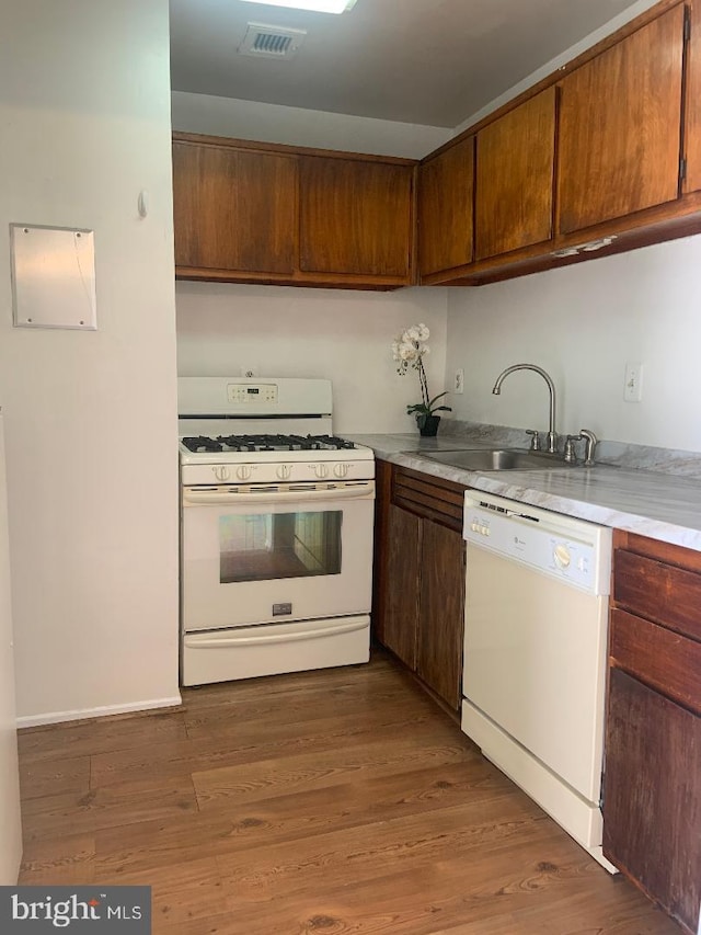 kitchen featuring sink, white appliances, and dark hardwood / wood-style floors