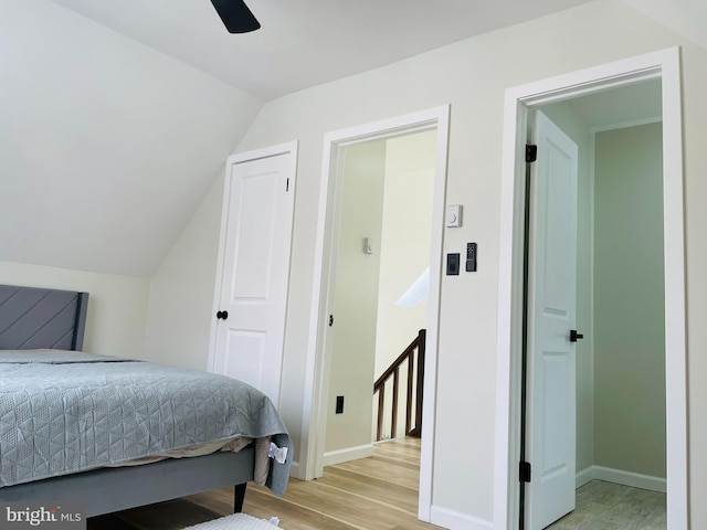 bedroom with lofted ceiling, light hardwood / wood-style flooring, and ceiling fan